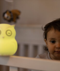 B HIBU Lifestyle Child in bed looking at yellow lighted toy